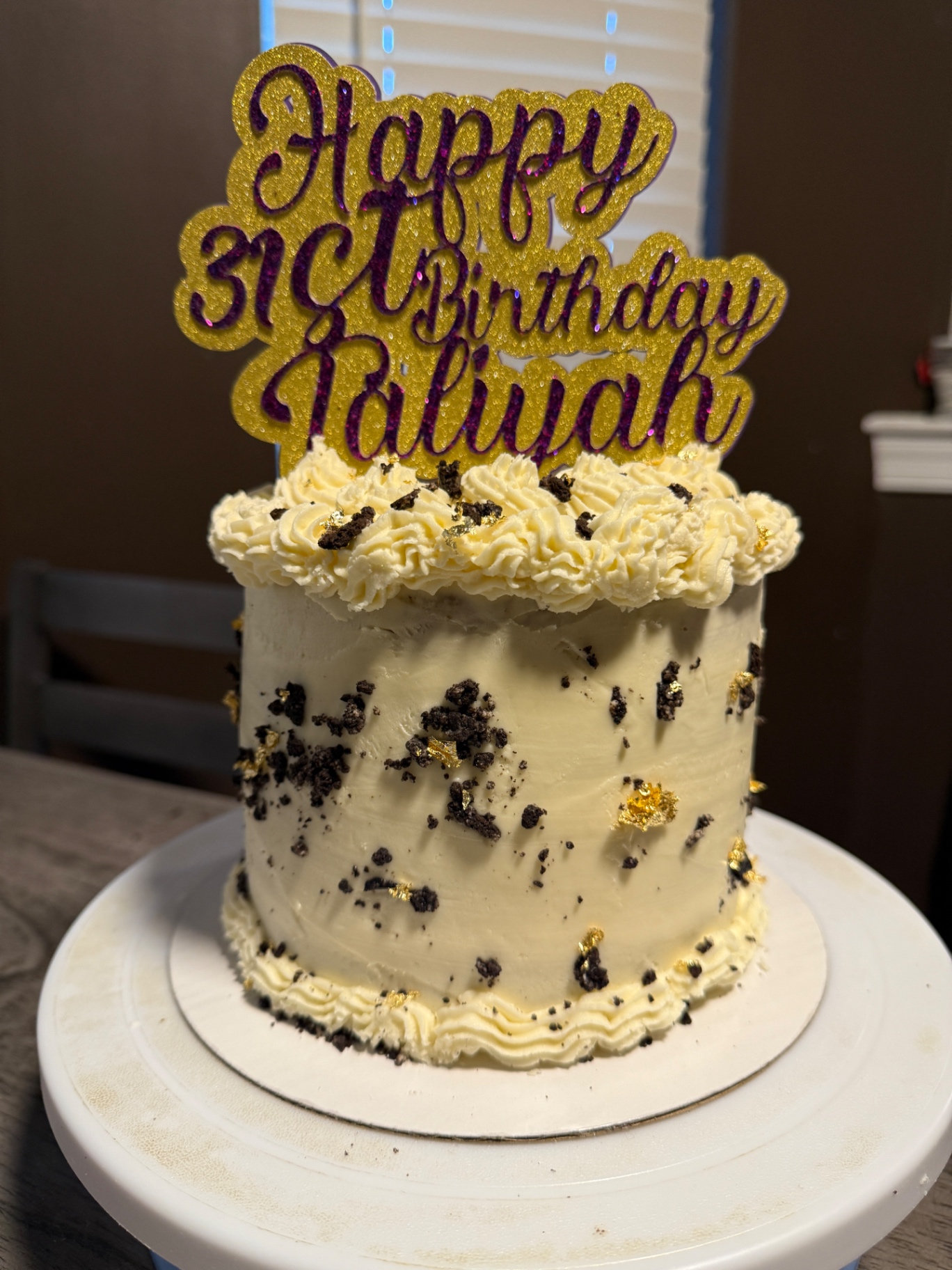 Cookies and cream cake with edible gold leaf and custom topper