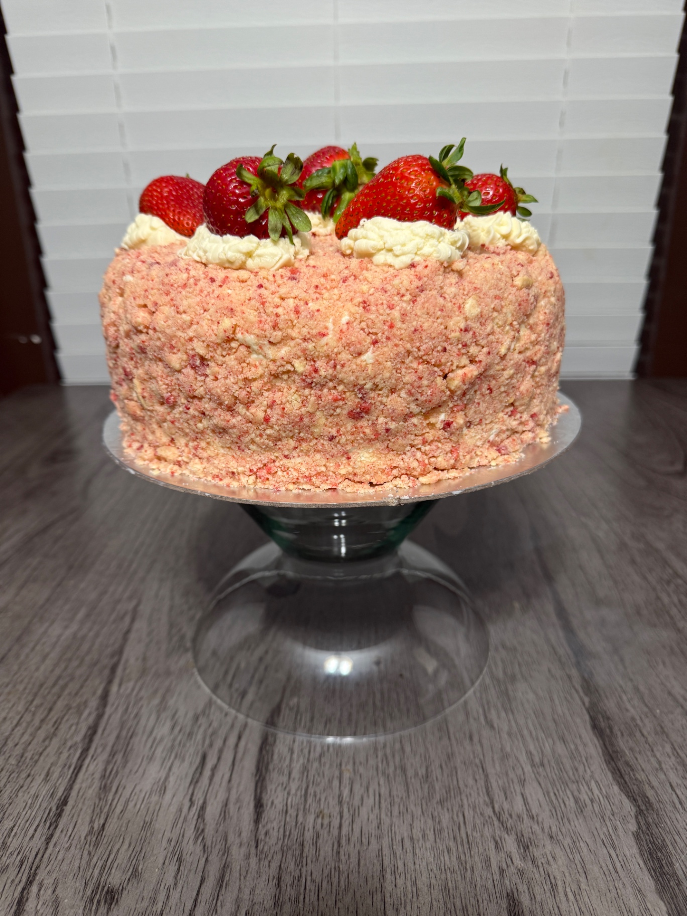 Strawberry crunch cake topped with fresh strawberries