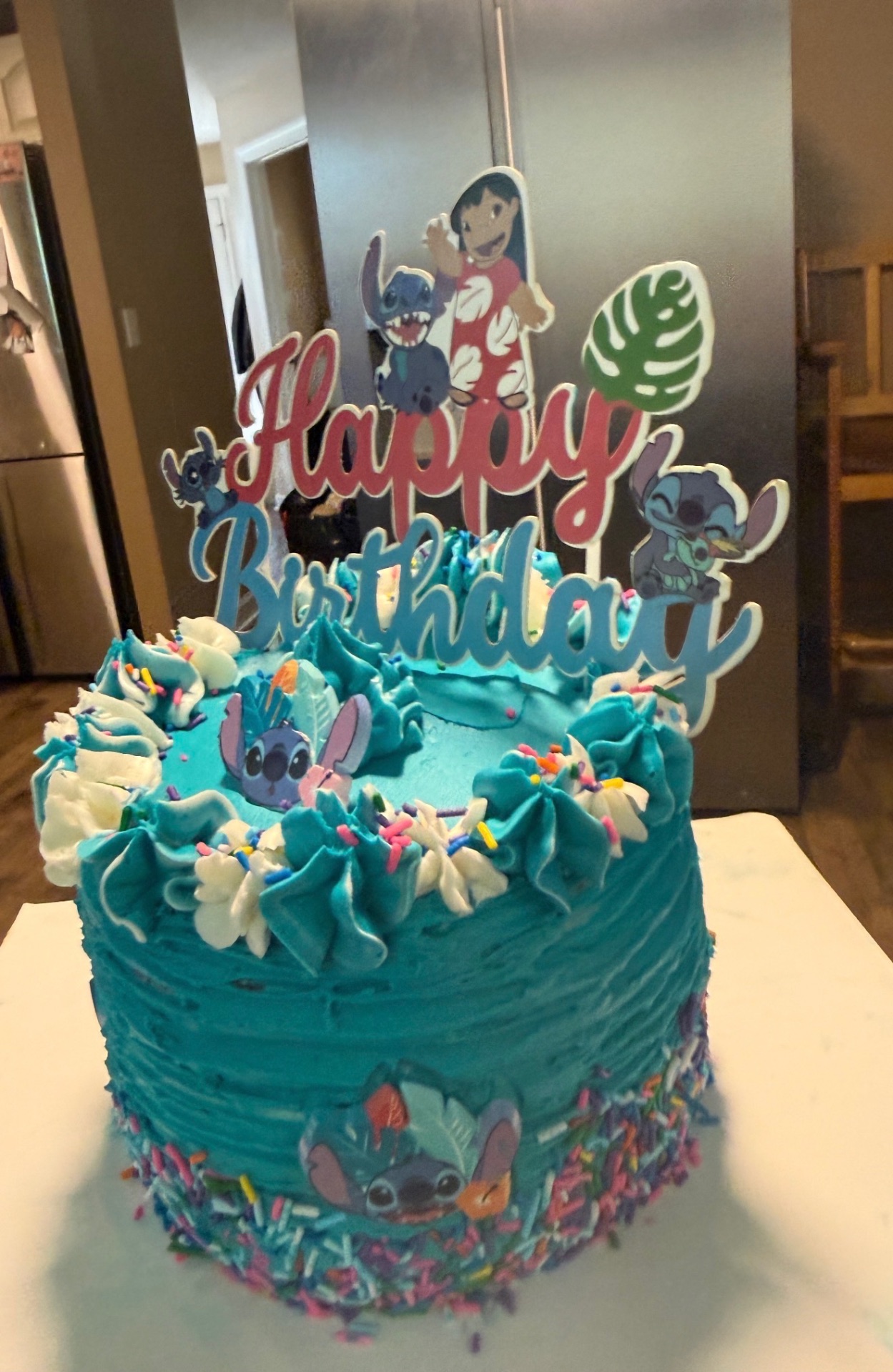 Teal Lilo and Stitch themed birthday cake with sprinkles